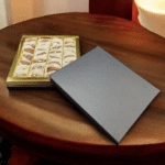 Box of assorted chocolates on a wooden table.